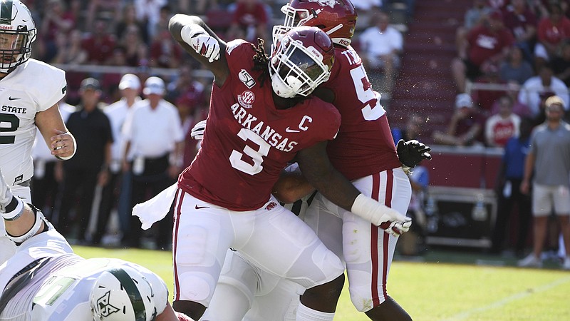  Arkansas defensive lineman McTelvin Agim reacts after making a big play against Portland State on Aug. 31, 2019, in Fayetteville, Ark. Agim, a former Hope High School player, was drafted by the Denver Broncos on Friday night in the third round. 