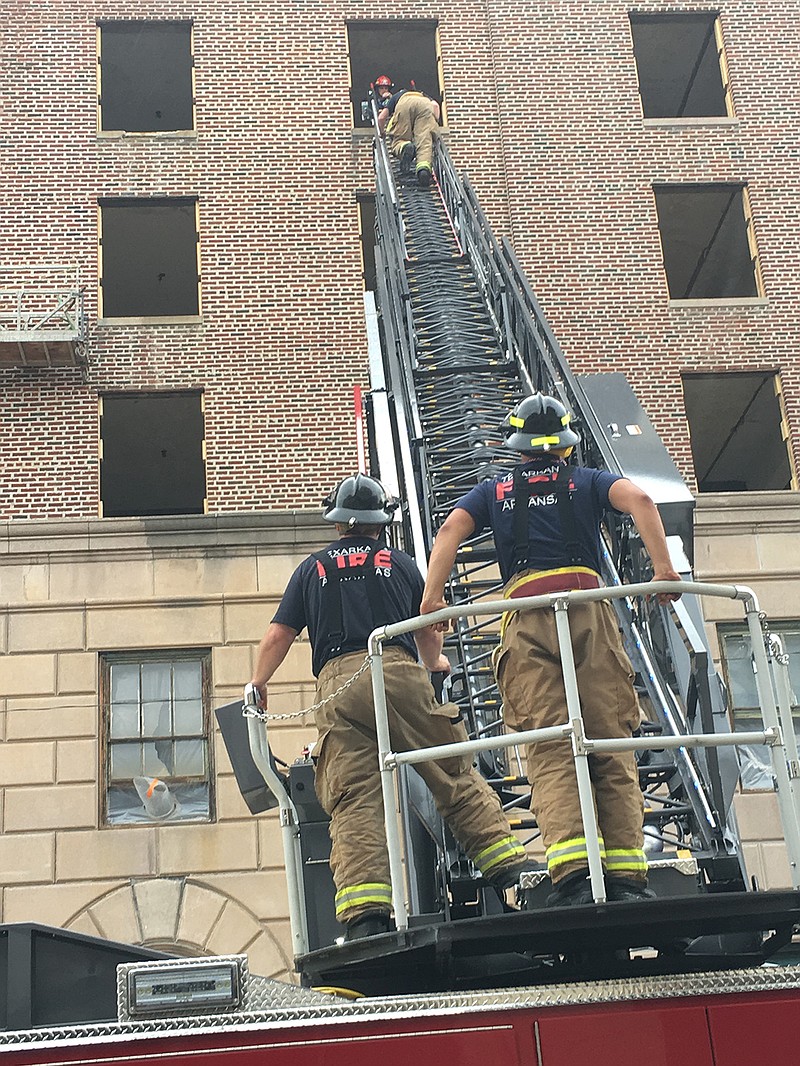 Texarkana, Arkansas, firefighters train Tuesday morning, entering and exiting a fifth-floor window of a property in downtown Texarkana that is being restored into apartments. The crew involved in the ladder truck training were Capt. Shane Richardson, driver Kevin Dildine, firefighter Tate Gore and firefighter Reece Jones. The ladder of Truck 1, when extended, is capable of reaching the top of the building, Richardson said.
