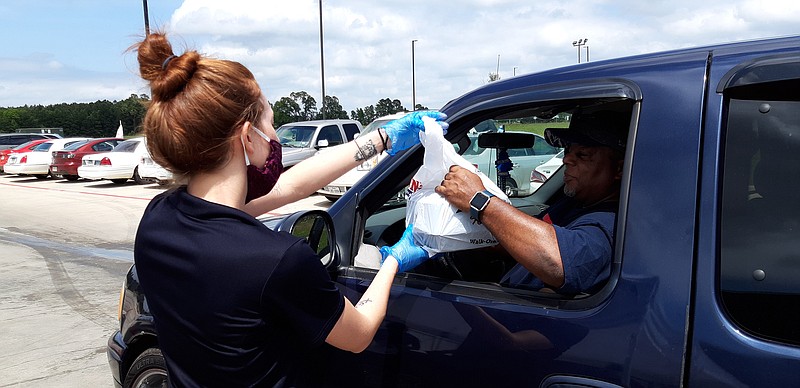 Walk-On's workers bring meals to furloughed workers Tuesday. Walk-On's has partnered with Furlough Kitchen to help during the COVID-19 crisis.