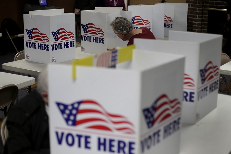 FILE - In this March 10, 2020, file photo, a man votes in the presidential primary election at the the Summit View Church of the Nazarene in Kansas City, Mo. A federal appeals court ruled Wednesday, April 29, 2020, that proof of citizenship requirement for Kansas voter registration is unconstitutional. (AP Photo/Charlie Riedel, File)