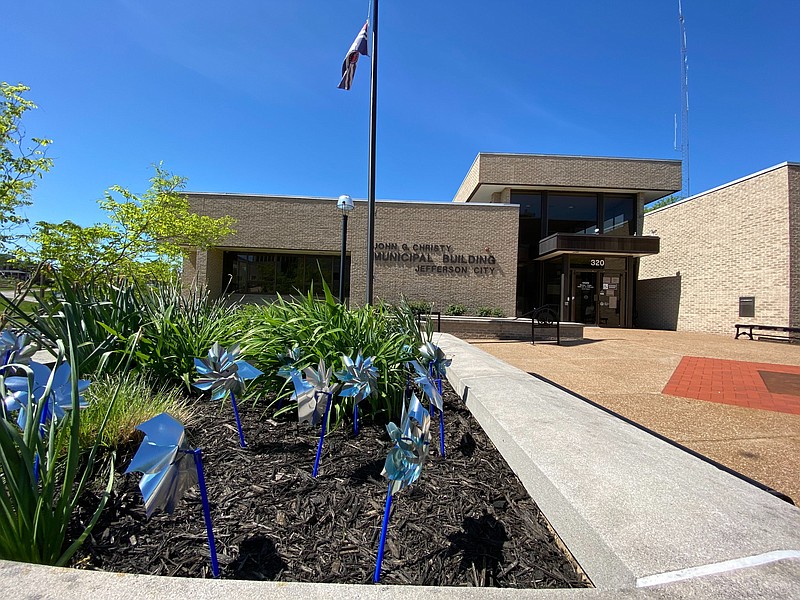 Pinwheels are on display as part of the landscaping near the front entrance of the John G. Christy Municipal Building, also known as City Hall, April 30, 2020, in Jefferson City.