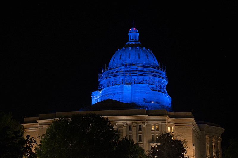 The Missouri State Capitol dome and the Law Enforcement Memorial in Jefferson City are shown lit blue Thursday, April 30, 2020, in honor of Missouri's law enforcement officers who have died in the line of duty.