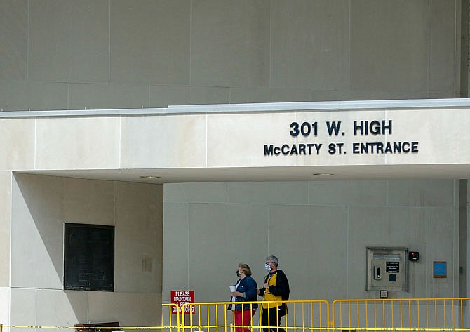 Employees leave the Harry S. Truman State Office Building in Jefferson City on Friday afternoon, May 1, 2020.