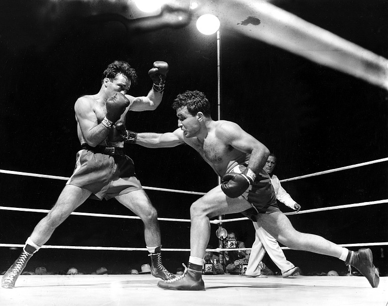 In this June 16, 1949, file photo, Jake LaMotta, right, fights Marcel Cerdan at Briggs Stadium in Detroit. LaMotta knocked out Cerdan in the 10th round to become the new world middleweight champion. The movie "Raging Bull," about the life of Jake Lamotta, was No. 7 in The Associated Press' Top 25 favorite sports movies poll.  (AP Photo/File)