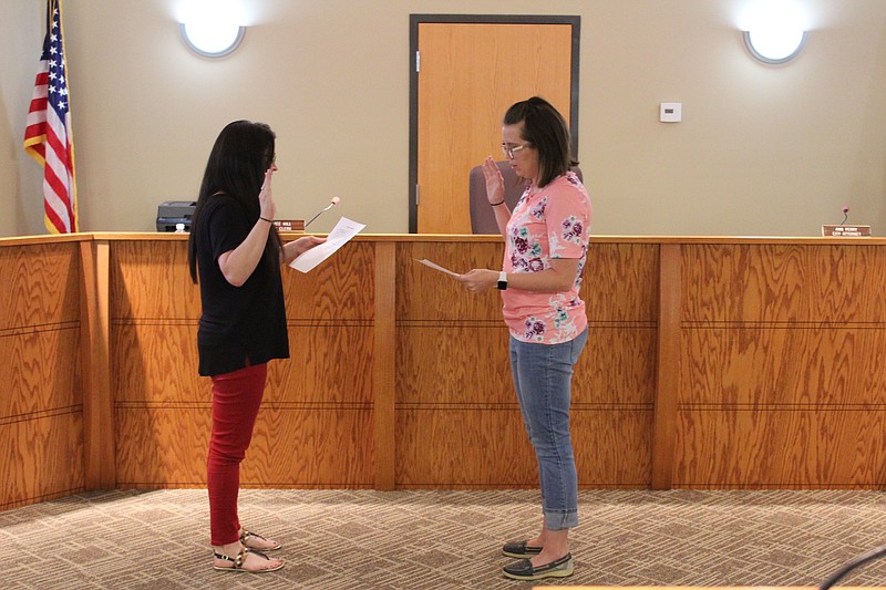 California City Clerk Aimee Hill, left, swears in new Ward I Alderwoman Lorrie Grimes at Monday's City Council meeting. Grimes was running unopposed for the seat on the upcoming June ballot.
