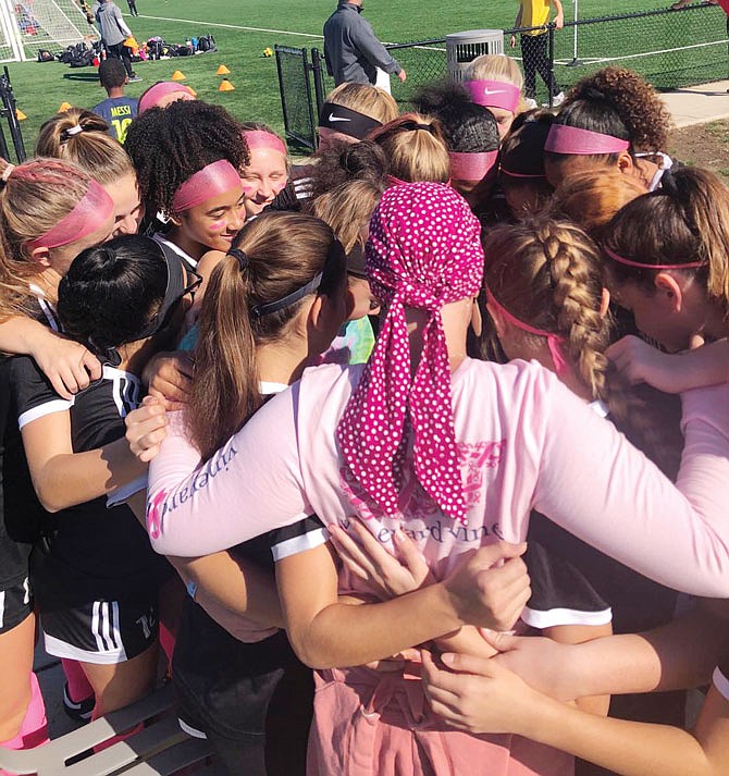 Lindsey Dyro hugs her daughter's soccer team after a game in St. Louis last October during Breast Cancer Awareness Month.