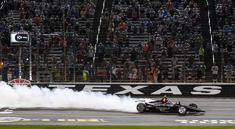 In this June 8, 2019, file photo, Josef Newgarden celebrates winning the IndyCar auto race at Texas Motor Speedway in Fort Worth, Texas. IndyCar has gotten the green flag to finally start its season in Texas. The race will be run June 6 without spectators at Texas Motor Speedway. (AP Photo/Randy Holt, File)