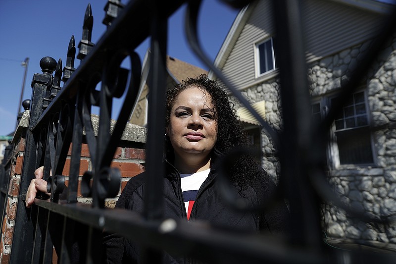 In this Thursday, May 7, 2020 photo, Nelis Rodriguez poses at her home in Chicago. Rodriguez has worked at the same restaurant for 21 years and in that time she never had to so much as think about getting another job. So, while she knew that much of the money she earns comes from tips and not the her $10-an-hour salary, she did not really appreciate what that meant until it was time to apply for unemployment. (AP Photo/Nam Y. Huh)