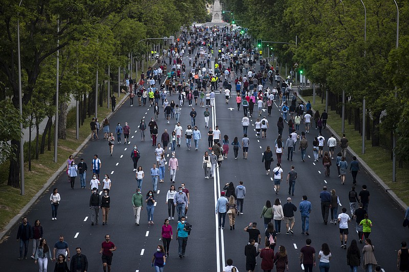 People exercise along Paseo de la Castellana after the lockdown measures imposed by the government due to coronavirus in Madrid, Spain, Saturday, May 9, 2020. Spain's Prime Minister has cautioned the nation that the loosening of its nearly two-month lockdown to stem the spread of the coronavirus will be for naught if people do not obey social distancing rules and hygiene recommendations. (AP Photo/Manu Fernandez)