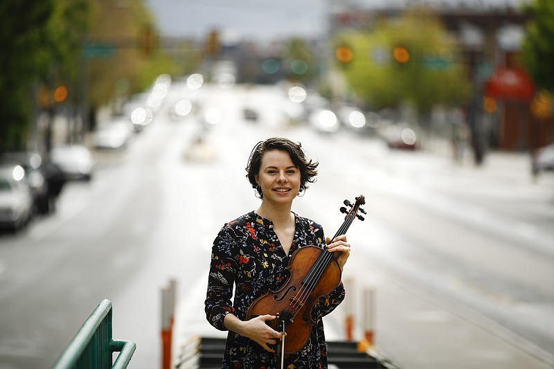 In this Friday, May 1, 2020, photo, violist Brooke Mead poses for a photograph in Philadelphia. Devastated by the cancellation of her graduate recital because of coronavirus concerns, Mead was invited to perform instead on the Philadelphia Orchestra’s live webcast. (AP Photo/Matt Rourke)