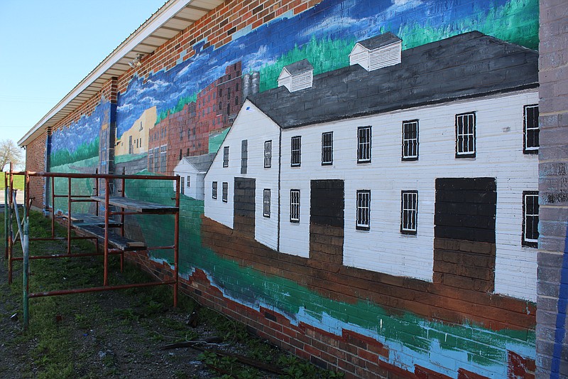 <p>Democrat photo/Austin Hornbostel</p><p>Work on the latest of California Progress, Inc.’s murals has begun to take shape. Buildings and details were added to the painted mural on the side of Robbie D’s last week. The last CPI mural was completed last August, just in time to be unveiled at the start of the Moniteau County Fair.</p>