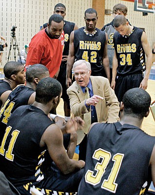 In this Feb. 8, 2006, file photo, Three Rivers Community College coach Gene Bess talks with his players during a timeout in a game against Southwestern Illinois College in Belleville, Ill.