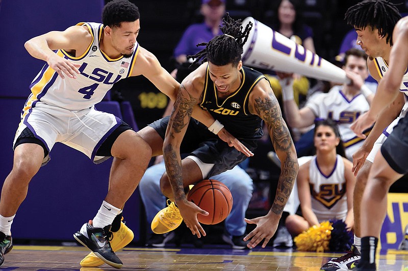 In this Feb. 11 file photo, Missouri forward Mitchell Smith (right) and LSU guard Skylar Mays (left) battle for control of a loose ball during a game in Baton Rouge, La. 