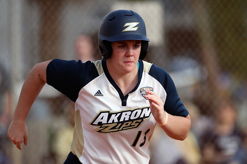 In this Feb. 14, 2020, file photo, University of Akron infielder Sydney Jascoe runs during an NCAA college softball game in Madeira Beach, Fla. Akron is dropping men's golf and cross country and women's tennis in cost-cutting moves due to the COVID-19 pandemic. The school said the reduction will take effect at the end of the 2019-20 academic year.(AP Photo/Mark LoMoglio, File)