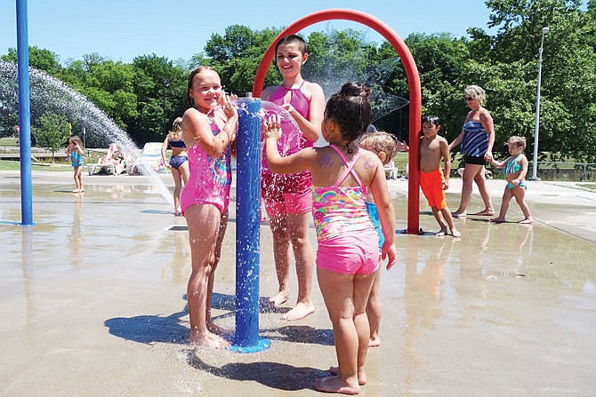 FILE: Local children enjoy the weather in 2018 at the Memorial Park splash pad. The city is on the fence about whether to reopen the popular water feature this summer.