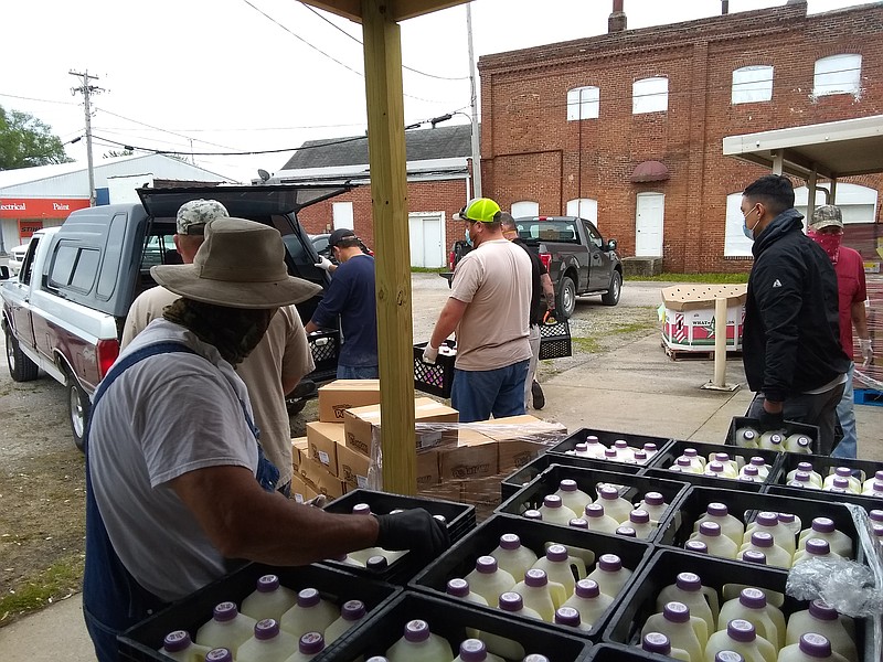 More than a dozen volunteers from California and Moniteau County Sheriff's Department assisted the California Nutrition Center May 14, 2020, with distributing more than 13,000 pounds of food (frozen chickens, potatoes, milk and watermelons) provided by the The Food Bank for Central & Northeast Missouri for Aging Best senior nutrition programs.