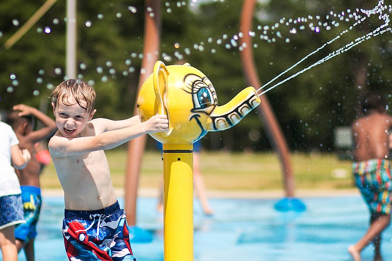 In this file photo, Lincoln Hargrave sprays water June 30, 2017, at the Rotary Splash Pad at Spring Lake Park. Families have been coming to the splash pad to stay cool while playing in the summer heat since it opened in 2012.