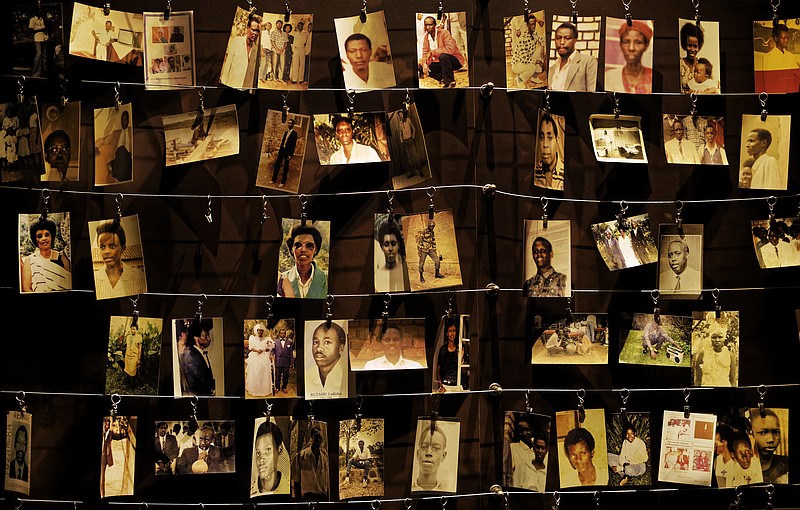 FILE - In this Friday, April 5, 2019 file photo, family photographs of some of those who died hang on display in an exhibition at the Kigali Genocide Memorial centre in the capital Kigali, Rwanda. Felicien Kabuga, one of the most wanted fugitives in Rwanda's 1994 genocide who had a $5 million bounty on his head, has been arrested in Paris, authorities said Saturday, May 16, 2020. (AP Photo/Ben Curtis, File)