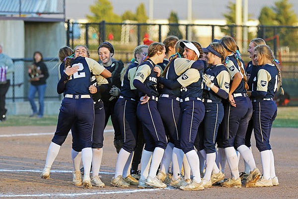The Helias Lady Crusaders celebrate after defeating the Sullivan Lady Eagles 3-1 to win the Class 3 state softball championship in Springfield.