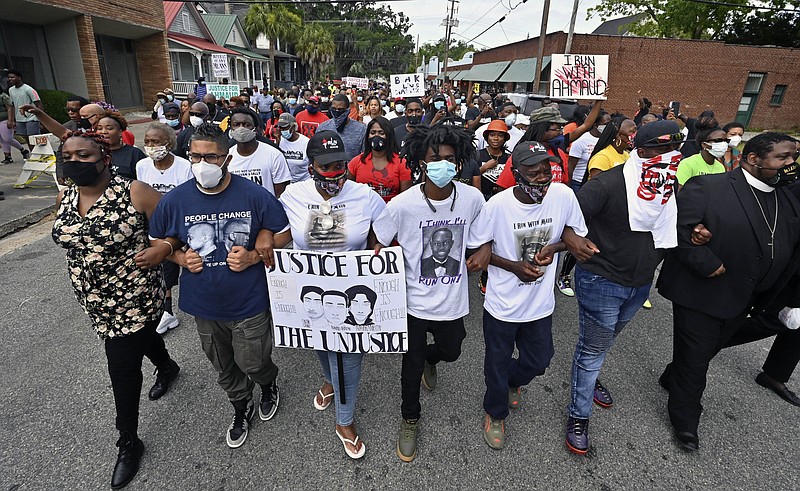 Protesters march after a rally at the Glynn County Courthouse to protest the shooting of Ahmaud Arbery, Saturday, May 16, 2020, in Brunswick, Ga. (Hyosub Shin/Atlanta Journal-Constitution via AP)