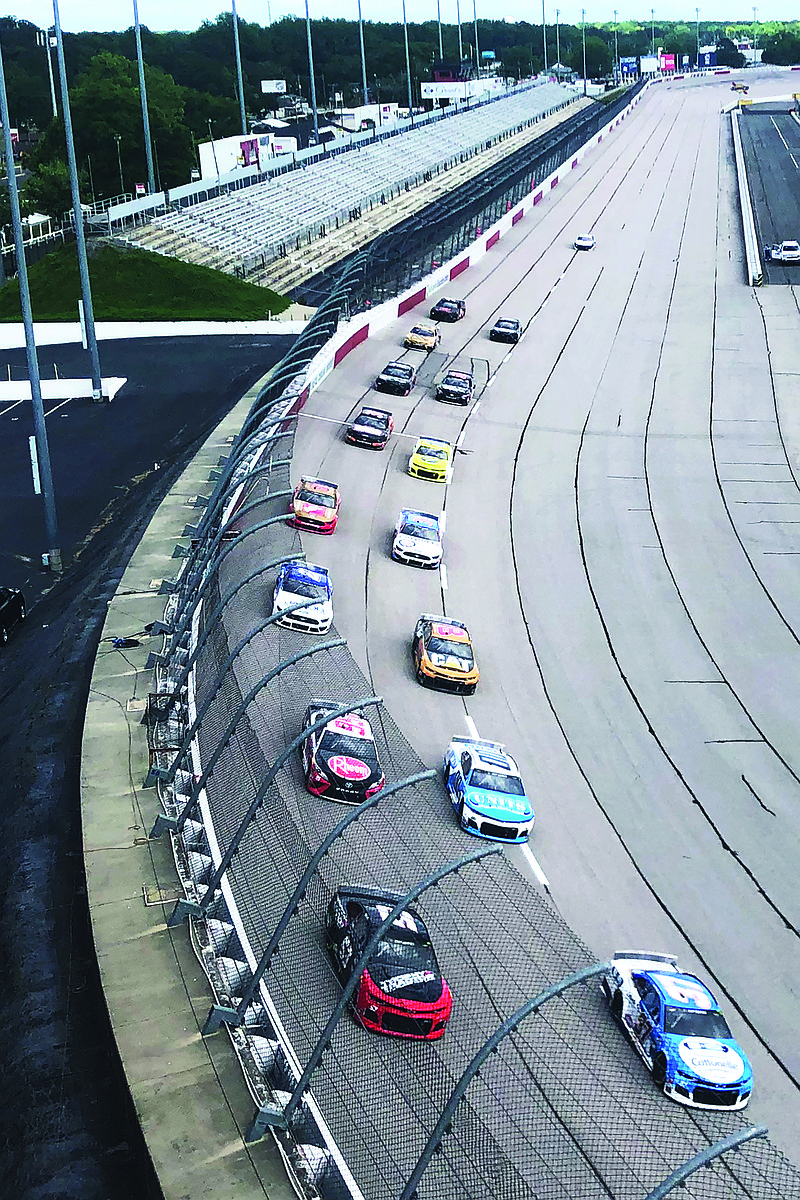 Drivers head through a turn in front of an empty grandstand during the NASCAR Cup Series race Sunday at Darlington Raceway in Darlington, S.C.