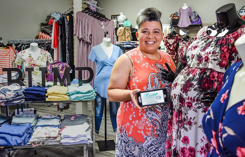 Julie Smith/News Tribune Paula Stallings poses in her new shop, Bump Boutique, at 312 Stadium Dr. The shop provides maternity and nursing wear, as well as diaper bags and more.