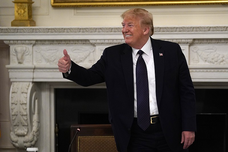 President Donald Trump gestures as he leaves a meeting with restaurant industry executives about the coronavirus response, in the State Dining Room of the White House, Monday, May 18, 2020, in Washington. (AP Photo/Evan Vucci)