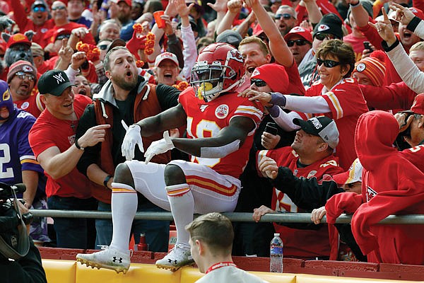 In this Nov. 3, 2019, file photo, Chiefs wide receiver Tyreek Hill celebrates with fans after he scored a touchdown during a game against the Vikings at Arrowhead Stadium.