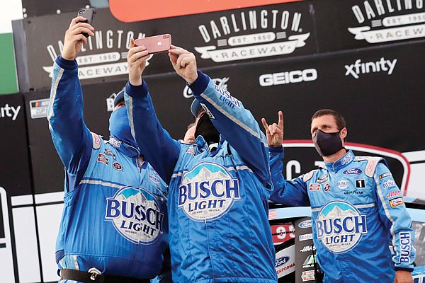 Members of Kevin Harvick's team celebrate after winning the NASCAR Cup Series race Sunday in Darlington, S.C.