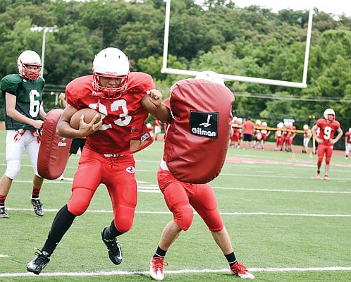 A Jefferson City player uses his forearm to work through pads during a practice at Adkins Stadium. If practice started today, pads like this would not be allowed under recommendations by the National Federation of High Schools.