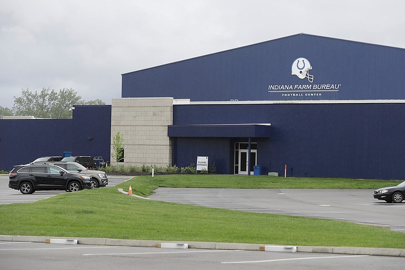 A parking lot is nearly empty in front of the Indianapolis Colts training facility, Tuesday, May 19, 2020, in Indianapolis. Coaching staffs and all players except those undergoing injury rehabilitation are barred from the facilities in the first phase of the league's plan. (AP Photo/Darron Cummings)