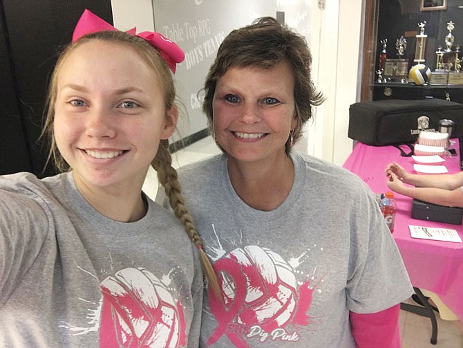 Karen Dungan, right, is pictured with her daughter, Eyla, at the October 2019 Fulton High School volleyball Pink Out game.