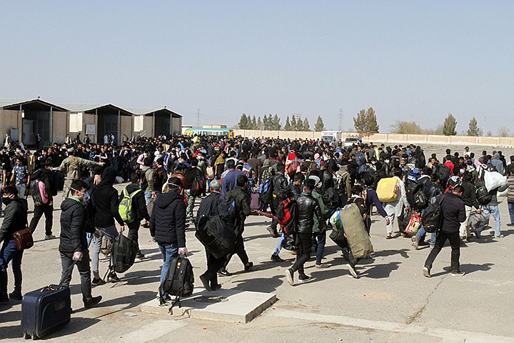 FILE - In this March 18, 2020, file photo, thousands of Afghan refugees walk as they enter Afghanistan at the Islam Qala border crossing with Iran, in the western Herat Province. An international aid group says Friday, May 22, 2020 that some 661,000 people in 19 countries have been displaced by armed conflict in the two months since the U.N. secretary general called for a global cease-fire to help curb the coronavirus pandemic. The Norwegian Refugee Council says in a report Friday that the bulk of the newly displaced were in the Democratic Republic of Congo, but that large numbers were also uprooted in Yemen, Afghanistan, Chad and Niger. (AP Photo/Hamed Sarfarazi)