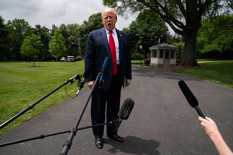 President Donald Trump talks to reporters before departing the White House for a trip to Michigan, Thursday, May 21, 2020, in Washington. (AP Photo/Evan Vucci)