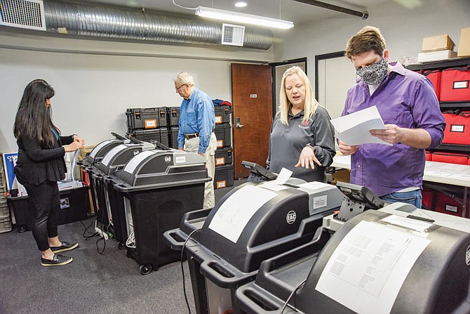 Chief Deputy Clerk Dawn Cremeans, second from right, instructs Josh Dunne on the process of running sample ballots through the voting machines. Deputy Clerk Dana Nichols, in background, works with testing veteran Roger Scrivner to do the same. In preparation for the June 2 election, staff from the Cole County Clerk's office and members of the Cole County Republican and Democrat parties performed the routine testing on the ballot machines to make sure that all are working correctly.