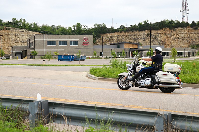 
A Jefferson City Police Department motorcyclist rides past the Special Olympics Missouri Training Center, leading the Restoring Hope Care-A-Van through Jefferson City Friday morning. The Care-A-Van, organized by the Cole and Miller County Long-Term Recovery Committee and other community leaders and organizations, included approximately 20 vehicles. The Care-A-Van was hosted in honor of Jefferson City's one-year anniversary of the EF3 tornado, which swept through the city on May 23, 2019.