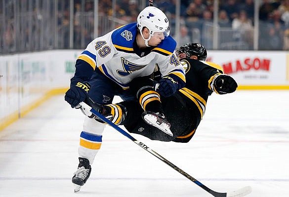 In this Oct. 26, 2019, file photo, Ivan Barbashev of the Blues checks Chris Wagner of the Bruins during a game in Boston.