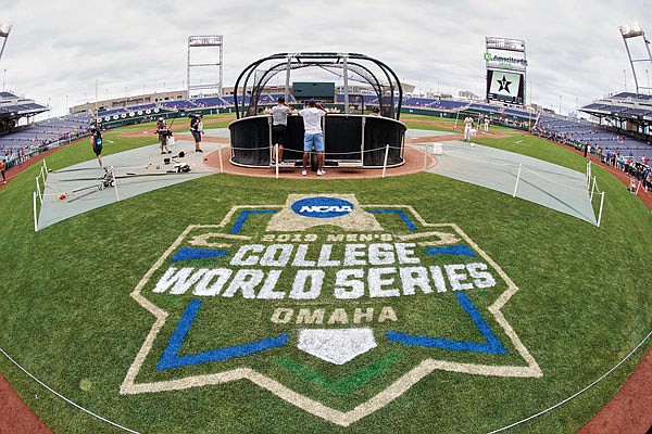 In this June 14, 2019, file photo, the College World Series logo is partially painted at TD Ameritrade Park in Omaha, Neb., as Vanderbilt players practice ahead of their game against Louisville.