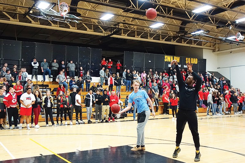 A.J. Reid, left, and Anthony Paine, then seniors at Fulton High School, shoot "Hoops for Heart" during an assembly to cap off 2019's Heart Week. 