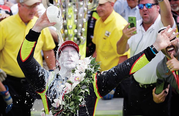 This May 26, 2019, file photo shows Simon Pagenaud celebrating after winning the Indianapolis 500 at Indianapolis Motor Speedway in Indianapolis.