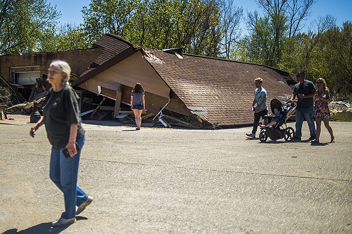 Sanford, Mich., residents survey the destruction in downtown Sanford, Thursday, May 21, 2020. The downtown area was decimated by severe flooding caused by dam failures upstream. (Katy Kildee/Midland Daily News via AP)