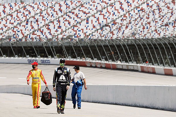 Drivers walk to their cars for the start of last Sunday's NASCAR Cup Series race in Darlington, S.C.