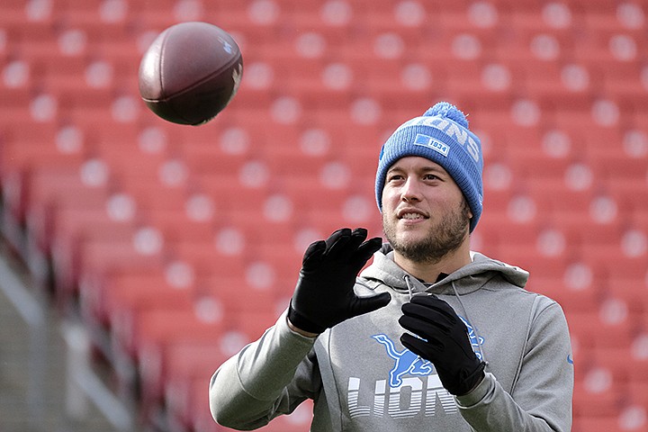 FILE - In this Nov. 24, 2019, file photo, Detroit Lions quarterback Matthew Stafford catches a football prior to an NFL football game against the Washington Redskins in Landover, Md. Some NFL quarterbacks are still finding ways to hold throwing sessions with receivers during the coronavirus pandemic, though things look much different. Stafford has thrown to Lions receivers Kenny Golladay and Danny Amendola in California. He connected with Lions tight end Isaac Nauta and rookies D'Andre Swift and Quintez Cephus in the Atlanta area. (AP Photo/Mark Tenally, File)