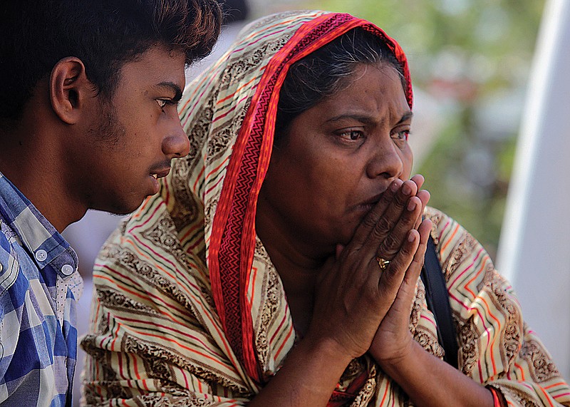 A woman reacts after identifying the body of her family member, who was killed in Friday's plane crash, Saturday at a morgue in Karachi, Pakistan. An aviation official says a passenger plane belonging to state-run Pakistan International Airlines carrying passengers and crew has crashed near the southern port city of Karachi. 