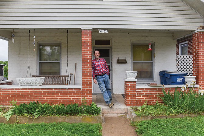 Vincent Kempker stands outside his home for a portrait. The Jefferson City School District wants to buy Kempker's home, but he said he is not selling it. "I've lived here too long to change my mind," he said.