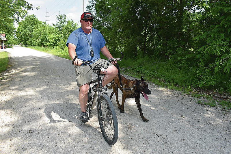 Holts Summit resident Jack Jones walks Tigger, his dutch malinois, Sunday morning, May 24, 2020, on the Katy Trail in North Jefferson City.