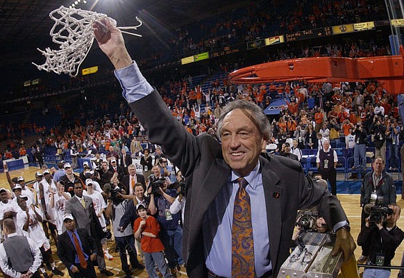 In this March 13, 2005, file photo, Oklahoma State coach Eddie Sutton waves the net as he celebrates the Cowboys' win against Texas Tech to win the Big 12 Tournament at Kemper Arena in Kansas City.