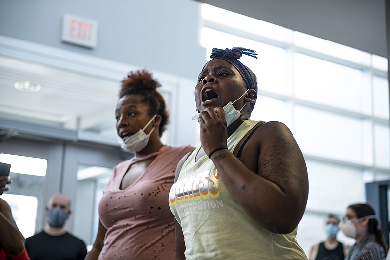Daughter of Sha' Teina Grady El, Jaquisy Grady speaks up with other protesters Tuesday, May 26, 2020 while gathered inside the Washtenaw County Sheriff's office to await an answer after a deputy was recorded punching her mother in the head multiple times during an arrest at the Washtenaw Sheriff's Office in Ypsilanti, Mich.(Nicole Hester/Ann Arbor News via AP)