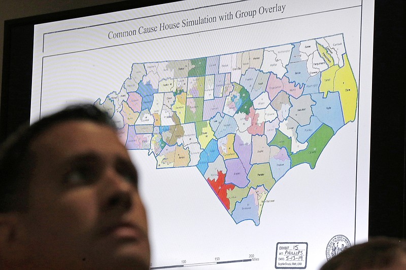 FILE - In this Monday, July 15, 2019 file photo, a state districts map is shown as a three-judge panel of the Wake County Superior Court presides over the trial of Common Cause, et al. v. Lewis, et al, in Raleigh, N.C. Drowned out by the coronavirus and national politics, Republican and Democratic operatives are nonetheless quietly preparing for a battle of state legislative supremacy later this year that could have a profound effect on political power for the next decade to come. This week, national Republicans are rolling out their first offensive target list for the November state legislative elections. Republican-led legislatures in Florida, Georgia, Iowa, Kansas, North Carolina, Pennsylvania, Texas and Wisconsin appear on both of their redistricting target lists. (AP Photo/Gerry Broome, File)