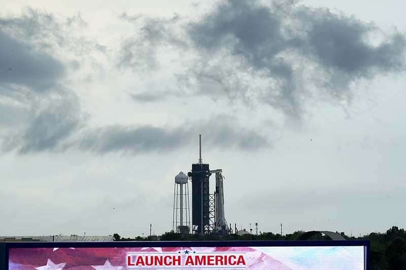 Clouds pass over the SpaceX Falcon 9, with the Crew Dragon spacecraft on top of the rocket, as it sits on Launch Pad 39-A Wednesday, May 27, 2020, at Kennedy Space Center in Cape Canaveral, Fla. Two astronauts will fly on the SpaceX Demo-2 mission to the International Space Station scheduled for launch Wednesday. (AP Photo/David J. Phillip)